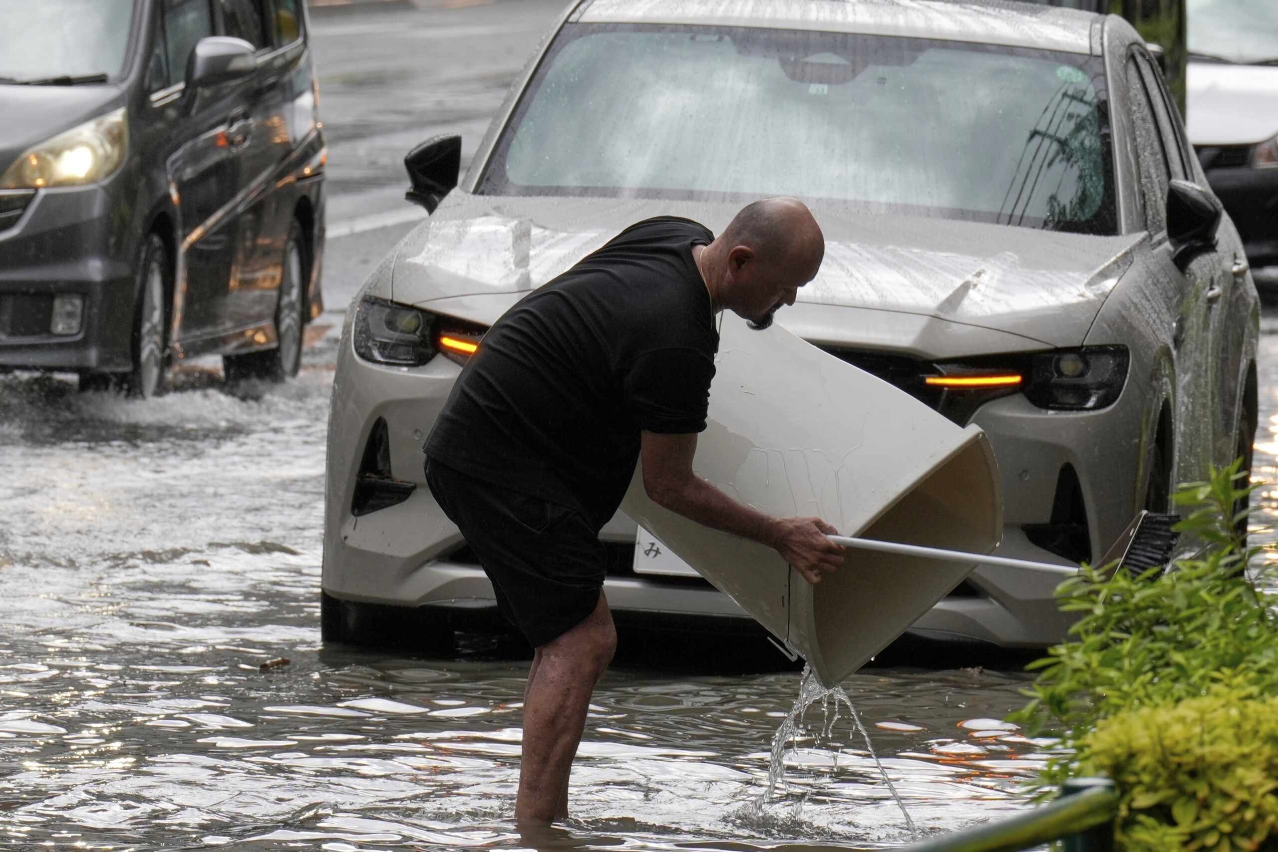 japan sudden rainfall in tokyo floods roads and blocks cars and trains scaled