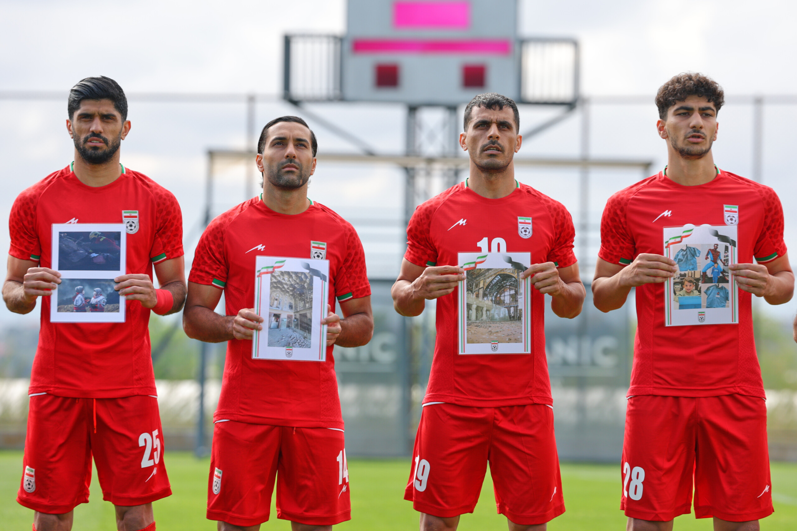 football iranian players take to the pitch against costa rica with photos of children killed by bombs scaled